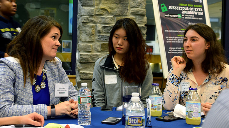 Three people talking at a table 